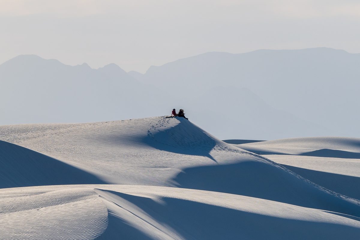 Two figures on a far ridge — White Sands, New Mexico